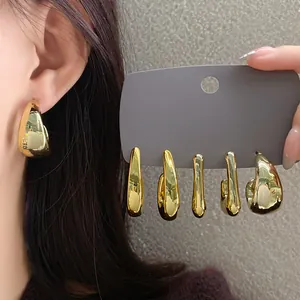 Detail view of various minimalist irregular gold geometric earrings on display