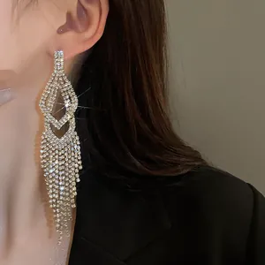 Macro-weergave van luxe zilveren lange kwastjes oorbellen met schitterende strass-steentjes