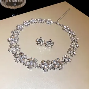 Elegant silver flower necklace and matching stud earrings set with sparkling rhinestones