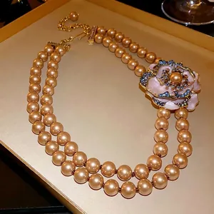 Vintage double-strand pearl necklace with elegant enamel flower and sparkling crystals
