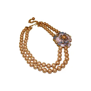 Elegant vintage double strand pearl necklace featuring a blue crystal flower pendant