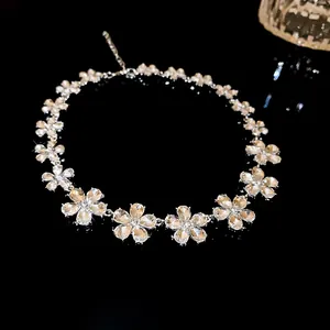 Detailed view of a sparkling crystal flower choker necklace on a black background