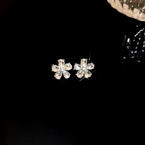 Macro view of crystal flower stud earrings featuring shimmering marquise cut stones
