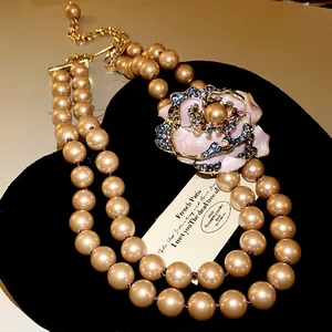 Detail shot of a French vintage necklace with pearls and a rhinestone flower pendant