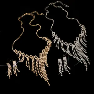 Detail view of luxury rhinestone fringe necklace and earrings set in gold and silver
