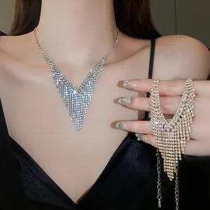Close-up of elegant sparkling rhinestone fringe necklace shown on model neck and hand
