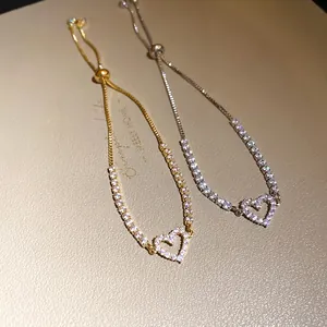 Elegant heart pendant bracelets set with sparkling cubic zirconia stones in gold and silver