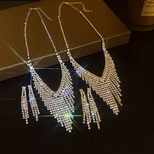 Close-up of glamorous gold and silver rhinestone fringe necklace and earring sets
