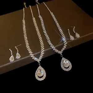 Close-up view of sparkling rhinestone water drop necklaces and matching earring sets