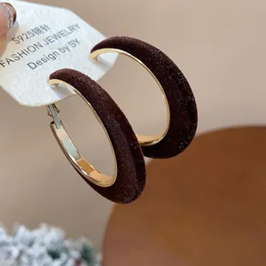 Macro detail of brown flocked hoop earrings with gold-tone metal frame and S925 needle.