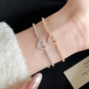 Macro view of elegant silver and gold heart pendant bracelets with sparkling zircons