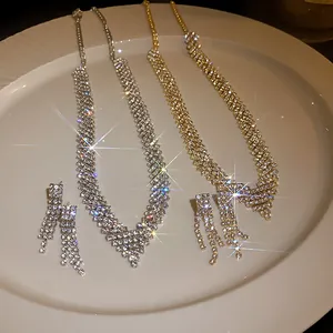 Elegant gold and silver rhinestone necklace and earring sets displayed on a luxury white plate