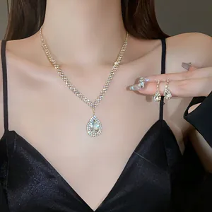Elegant sparkling rhinestone teardrop necklace and matching earring set shown on model