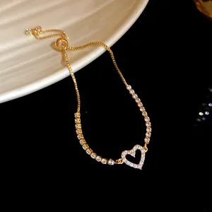 Detailed view of elegant gold-plated bracelet with shimmering zircon heart charm