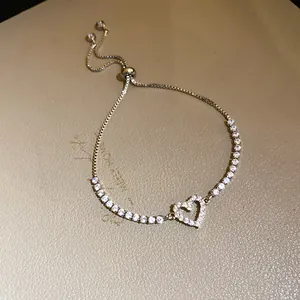 Close-up detail of a silver zircon heart pendant bracelet with adjustable slider clasp