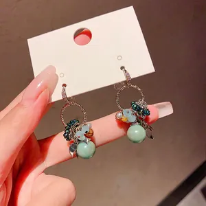 Bohemian style drop earrings with sparkling zircon accents and multi-colored glass beads.