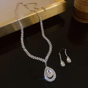 Detailed close-up view of elegant rhinestone teardrop necklace and matching earrings set