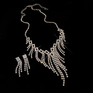 Detail of sparkling rhinestone fringe necklace and earrings set on black background