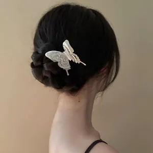 Ethereal silver butterfly hair stick styled in an elegant braided bun for women