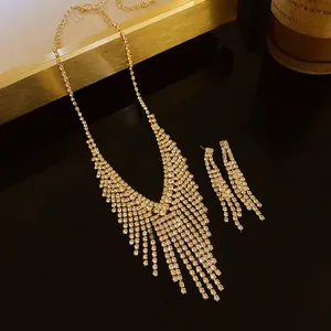 Detail shot of gold fringe necklace and earring set with sparkling rhinestones.