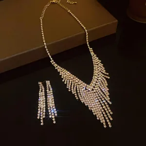 Macro detail of gold-toned rhinestone tassel necklace and earrings set