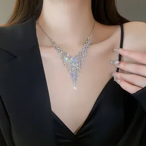 Close-up detail of an elegant V-shaped rhinestone tassel necklace worn on a model's neck.