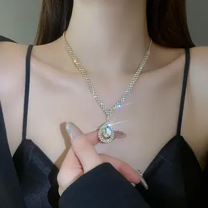 Close-up detail of a elegant silver waterdrop pendant necklace with sparkling rhinestones