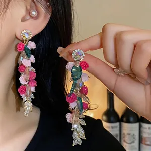 Elegant floral tassel earrings with pink roses and faceted crystals