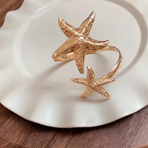 Elegant gold metal starfish open armband featuring a minimalist luxury coastal design style
