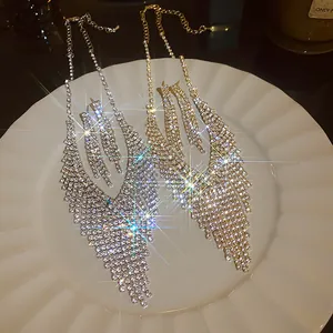 Detailed view of silver and gold rhinestone tassel jewelry sets on a white plate