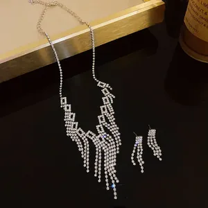 Detailed view of shimmering rhinestone tassels on a geometric necklace and earrings set.