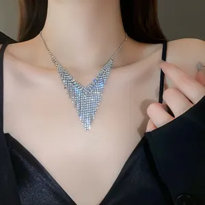 Close-up detail of a sparkling rhinestone V-shaped fringe choker necklace on a female model