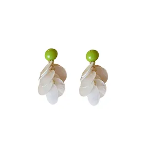 Chic silver needle earrings featuring bright green studs and dangling white shell tassels
