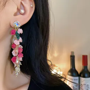Detailed view of handmade floral tassel earrings with sparkling crystal accents