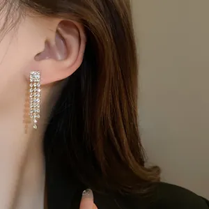 Detailed macro shot of elegant silver multi-strand rhinestone tassel drop earrings.
