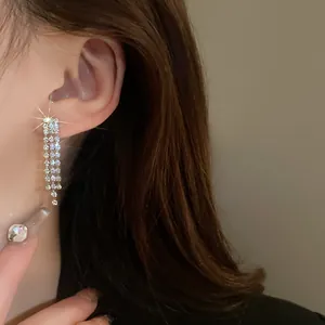Detailed close-up view of elegant silver three-row rhinestone tassel long drop earrings