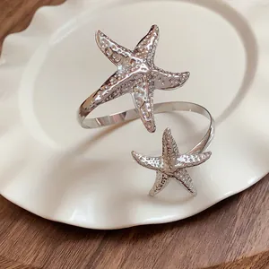 Detailed view of a silver metal starfish armlet featuring an intricate textured surface
