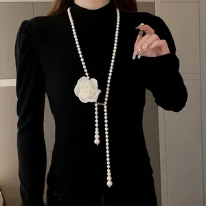 Elegant vintage long pearl sweater chain necklace featuring a large white camellia flower