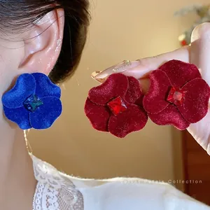 Oversized matte flower stud earrings with rhinestones for a bold fashion statement.