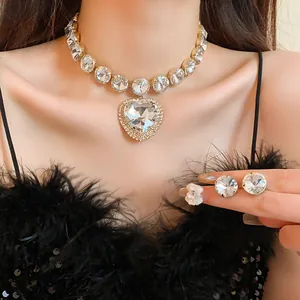 Detail view of luxury heart rhinestone necklace and matching stud earrings on model