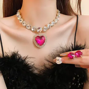 Close-up of luxury heart-shaped pink crystal necklace and stud earrings jewelry set
