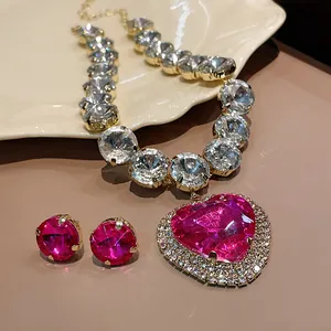 Detailed macro view of heavy pink heart rhinestone necklace and stud earrings set