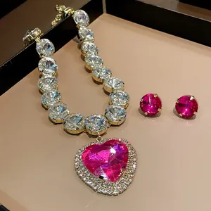 Luxury heart-shaped pink crystal necklace and earring set with rhinestones.