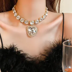 Close-up of heavy heart rhinestone necklace worn with black feather dress