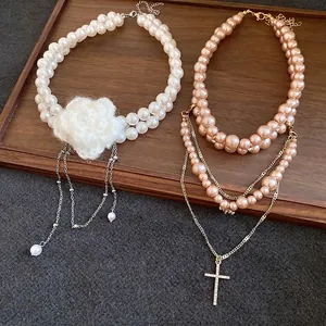 Vintage double-layer pearl necklaces featuring knitted white flower and cross pendant decor