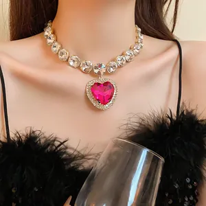 Close-up of a glamorous heart-shaped pink crystal necklace worn by a model
