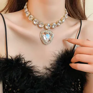 Close-up detail of a luxury heart-shaped crystal pendant and shimmering rhinestone choker