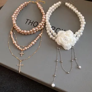 Elegant double-layer pearl necklace with knitted white flower and retro cross charms