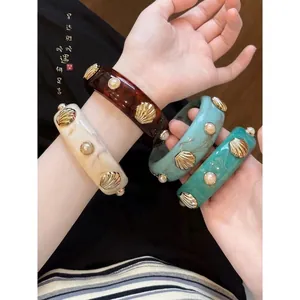 Acrylic statement bangle set featuring vintage shell and pearl accents for women