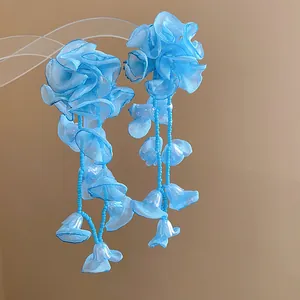 Detailed view of blue chiffon flower tassel earrings with elegant hanging bead strands